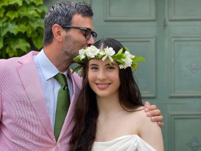 Reza Jarrahy is kissing Alizeh Keshvar Davis Jarrahy on her head.